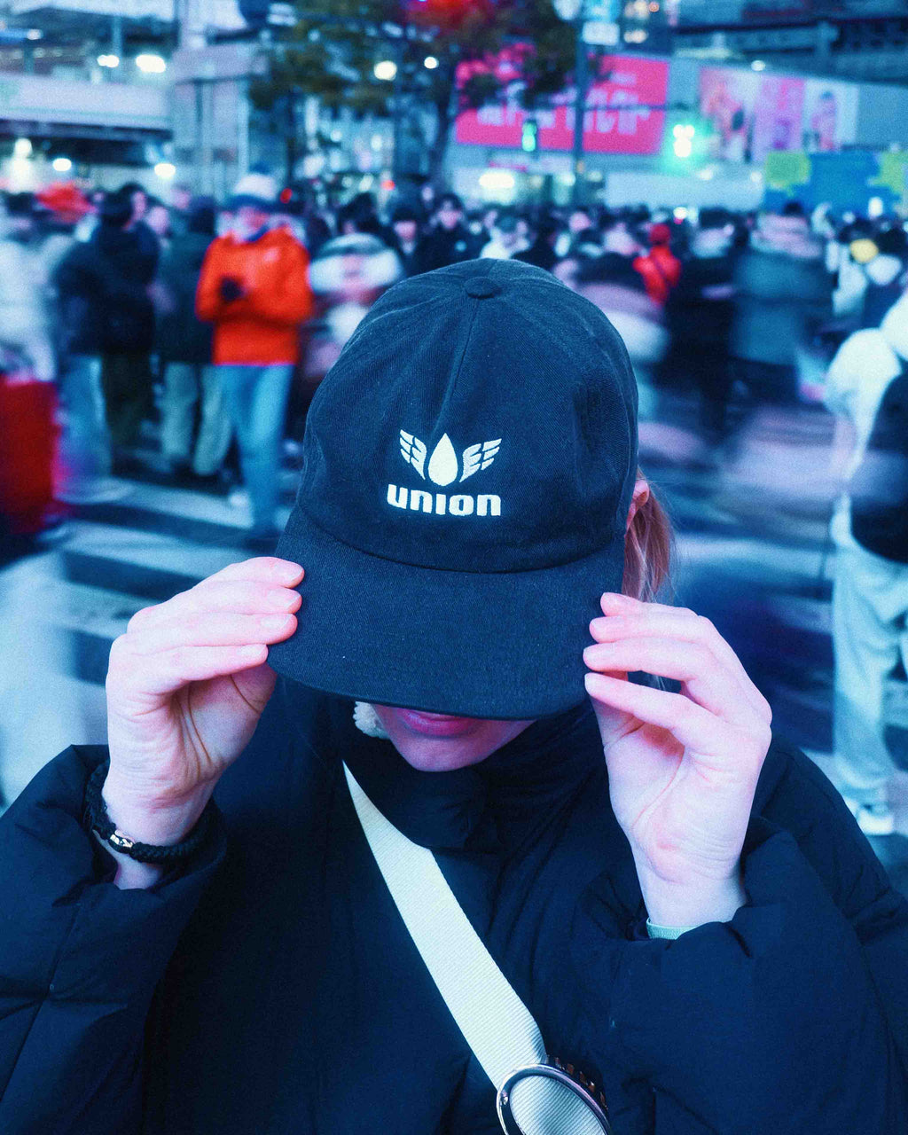 female model wearing Union.dsgn cap in city